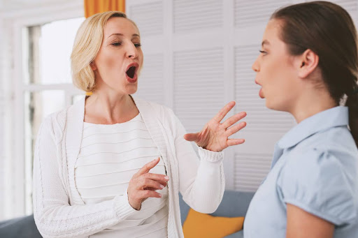 Try to sing. Beautiful musician teaching her student, actively gesticulating